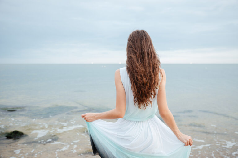A gentle and quiet woman by the ocean