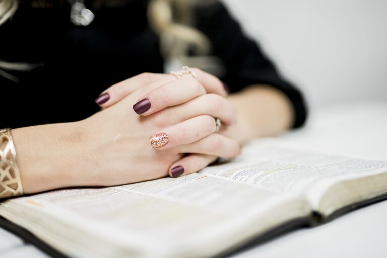 Woman reading her Bible and praying